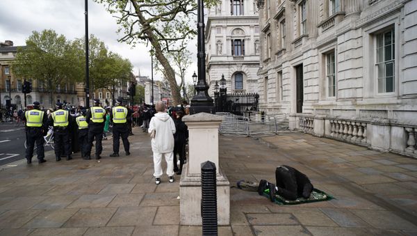A man prays as people gather outside Downing Street to protest against Israeli attacks on Palestinians in Gaza, in London, Saturday, May 15, 2021 - Sputnik International