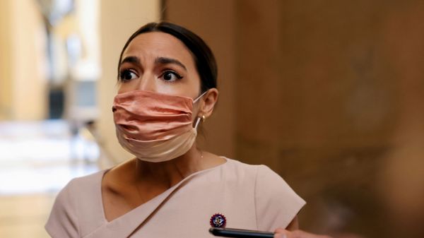 U.S. Representative Alexandria Ocasio-Cortez reacts as she walks past reporters on Capitol Hill in Washington, U.S., May 13, 2021 - Sputnik International