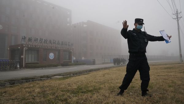 A security official moves journalists away from the Wuhan Institute of Virology after a World Health Organization team arrived for a field visit in Wuhan in China's Hubei province on Wednesday, Feb. 3, 2021 A security official moves journalists away from the Wuhan Institute of Virology after a World Health Organization team arrived for a field visit in Wuhan in China's Hubei province on Wednesday, Feb. 3, 2021 - Sputnik International