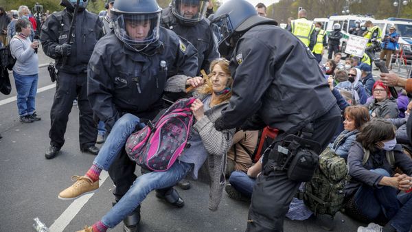 Police officers carry away a demonstrator after police stop a protest rally against the German government's policy to battle the corona virus pandemic in Berlin, Germany, Wednesday, April 21, 2021. - Sputnik International