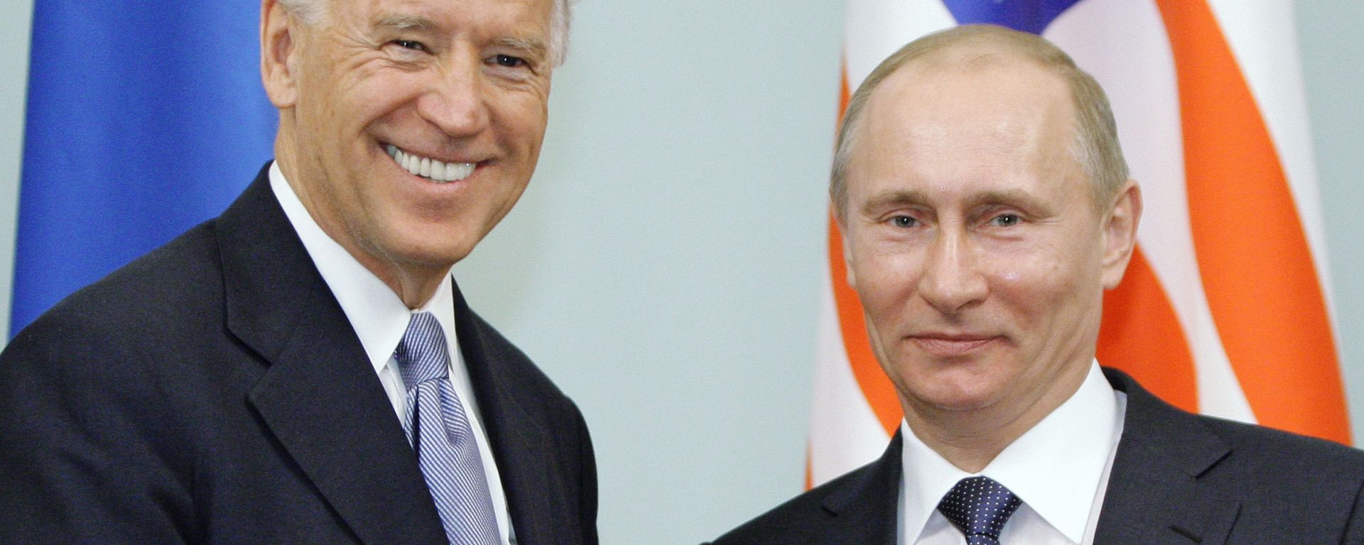 In this March 10, 2011 file photo, then Vice President  Joe Biden, left, shakes hands with Russian Prime Minister Vladimir Putin in Moscow, Russia. - Sputnik International, 1920, 07.06.2021