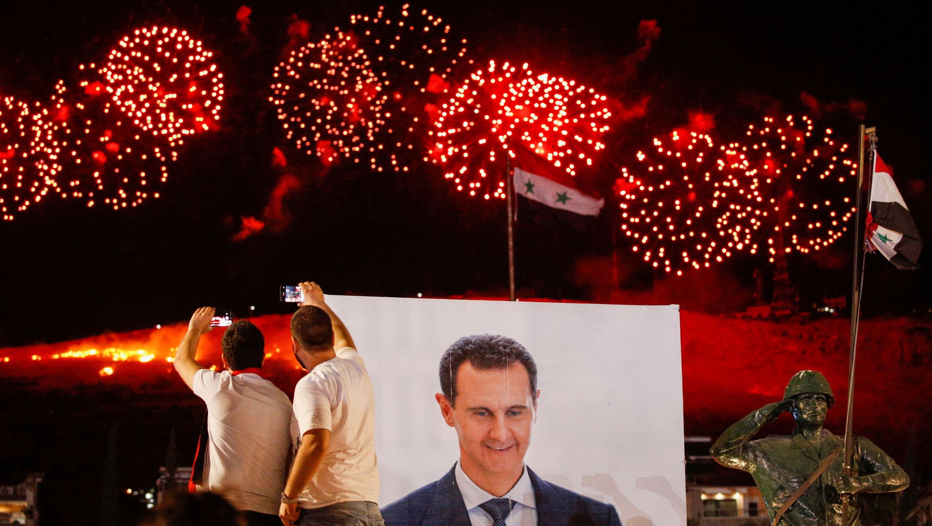 A poster depicting Syria’s president Bashar al- Assad is seen as supporters of of Syria's President Bashar al-Assad celebrate after the results of the presidential election announced that he won a fourth term in office, in Damascus, Syria, May 27, 2021. A poster depicting Syria’s president Bashar al- Assad is seen as supporters of of Syria's President Bashar al-Assad celebrate after the results of the presidential election announced that he won a fourth term in office, in Damascus, Syria, May 27, 2021. - Sputnik International, 1920, 27.05.2021