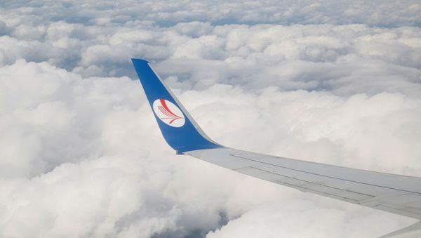 A wing of a plane of Belavia company is seen over clouds near Minsk, Belarus, July 19, 2016. - Sputnik International
