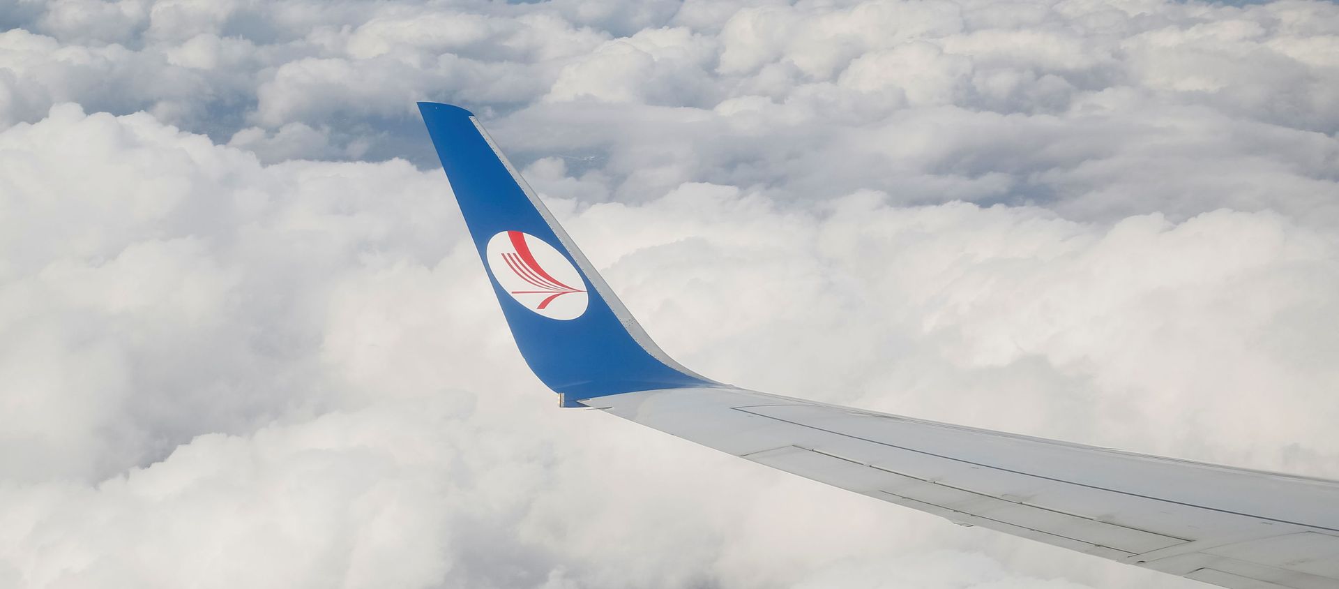 A wing of a plane of Belavia company is seen over clouds near Minsk, Belarus, July 19, 2016. - Sputnik International, 1920, 27.05.2021