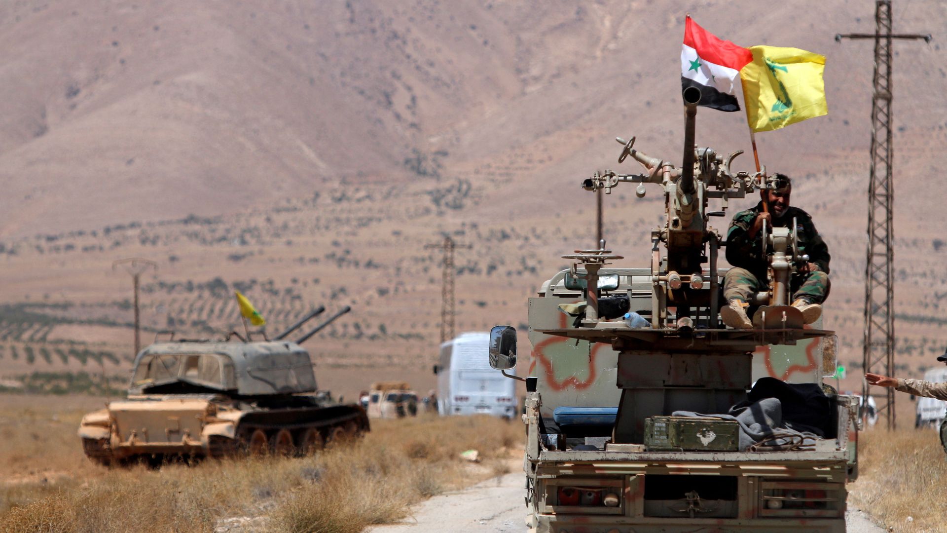 Hezbollah and Syrian flags flutter on a military vehicle in Western Qalamoun, Syria August 28, 2017. Hezbollah and Syrian flags flutter on a military vehicle in Western Qalamoun, Syria August 28, 2017. - Sputnik International, 1920, 29.05.2021