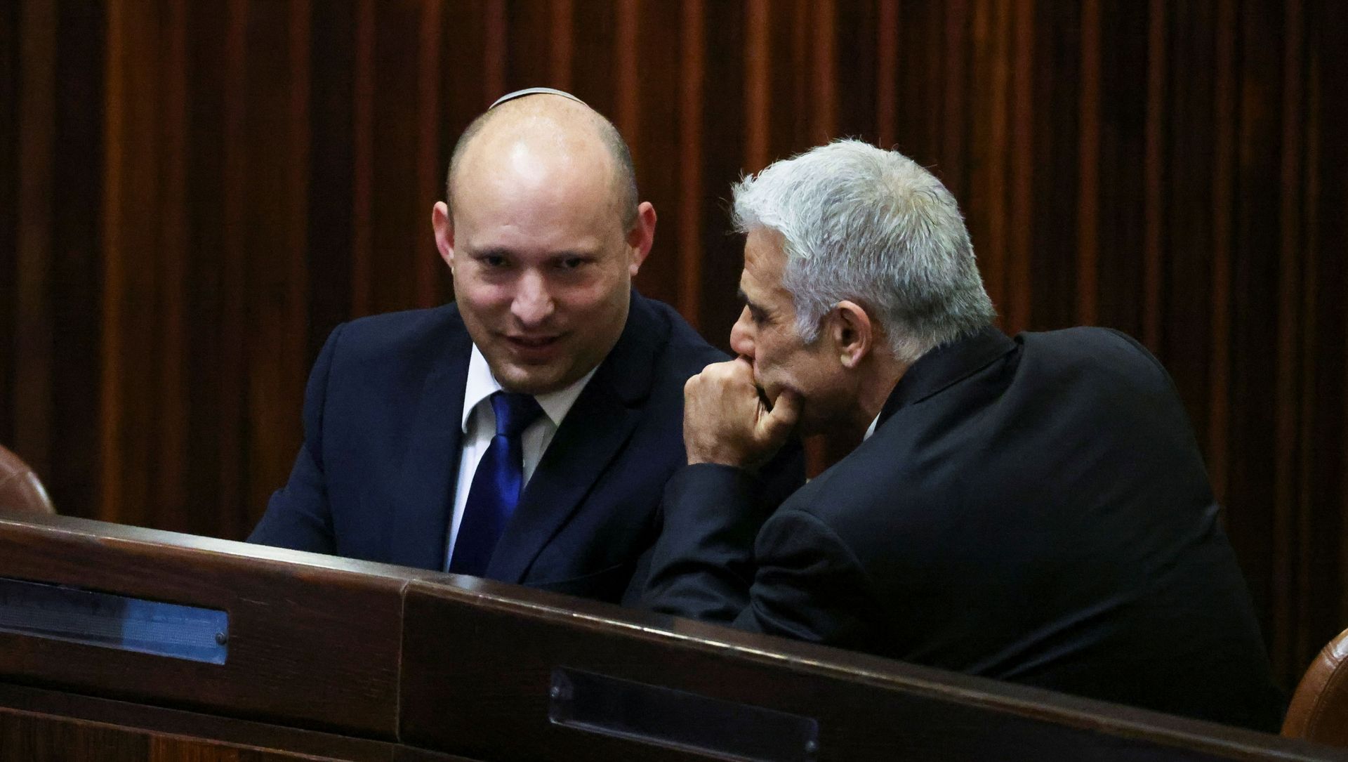 Yamina party leader Naftali Bennett smiles as he speaks to Yesh Atid party leader Yair Lapid, during a special session of the Knesset whereby Israeli lawmakers elect a new president, at the plenum in the Knesset, Israel's parliament, in Jerusalem June 2, 2021. Yamina party leader Naftali Bennett smiles as he speaks to Yesh Atid party leader Yair Lapid, during a special session of the Knesset whereby Israeli lawmakers elect a new president, at the plenum in the Knesset, Israel's parliament, in Jerusalem June 2, 2021. - Sputnik International, 1920, 02.06.2021
