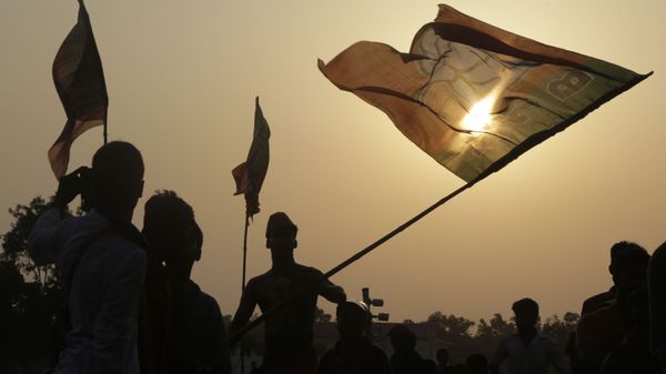 Supporters of India's ruling Bharatiya Janata Party (BJP) cheer with party flags as they attend  an election rally addressed by Indian Prime Minister Narendra Modi, in Mathurapur, south of Kolkata, India, Thursday, May 16, 2019 - Sputnik International