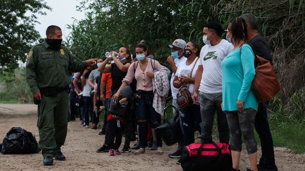 Migrants from Venezuela await transportation to a U.S. border patrol facility after crossing the Rio Grande river into the United States from Mexico in Del Rio, Texas, U.S., May 11, 2021 Migrants from Venezuela await transportation to a U.S. border patrol facility after crossing the Rio Grande river into the United States from Mexico in Del Rio, Texas, U.S., May 11, 2021 - Sputnik International