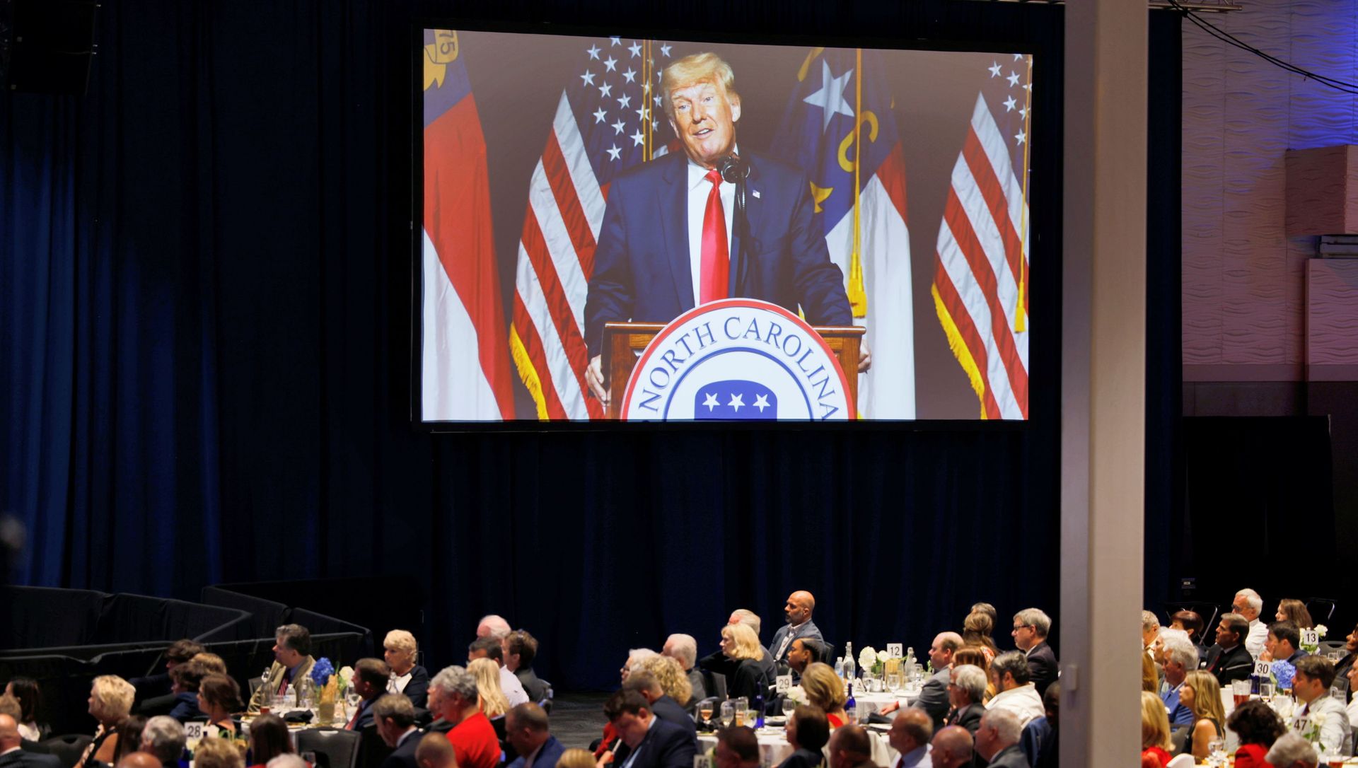 Former U.S. President Donald Trump appears on a giant live video screen as he speaks at the North Carolina GOP convention dinner in Greenville, North Carolina, U.S. June 5, 2021 - Sputnik International, 1920, 06.06.2021