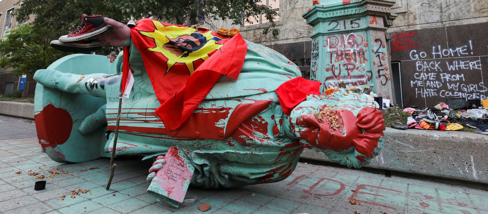 A person stands on a plinth after the defaced statue of Egerton Ryerson, considered an architect of Canada's residential indigenous school system, lies on the pavement after being toppled following a protest at Ryerson University in Toronto, Ontario, Canada June 6, 2021 - Sputnik International, 1920, 07.06.2021