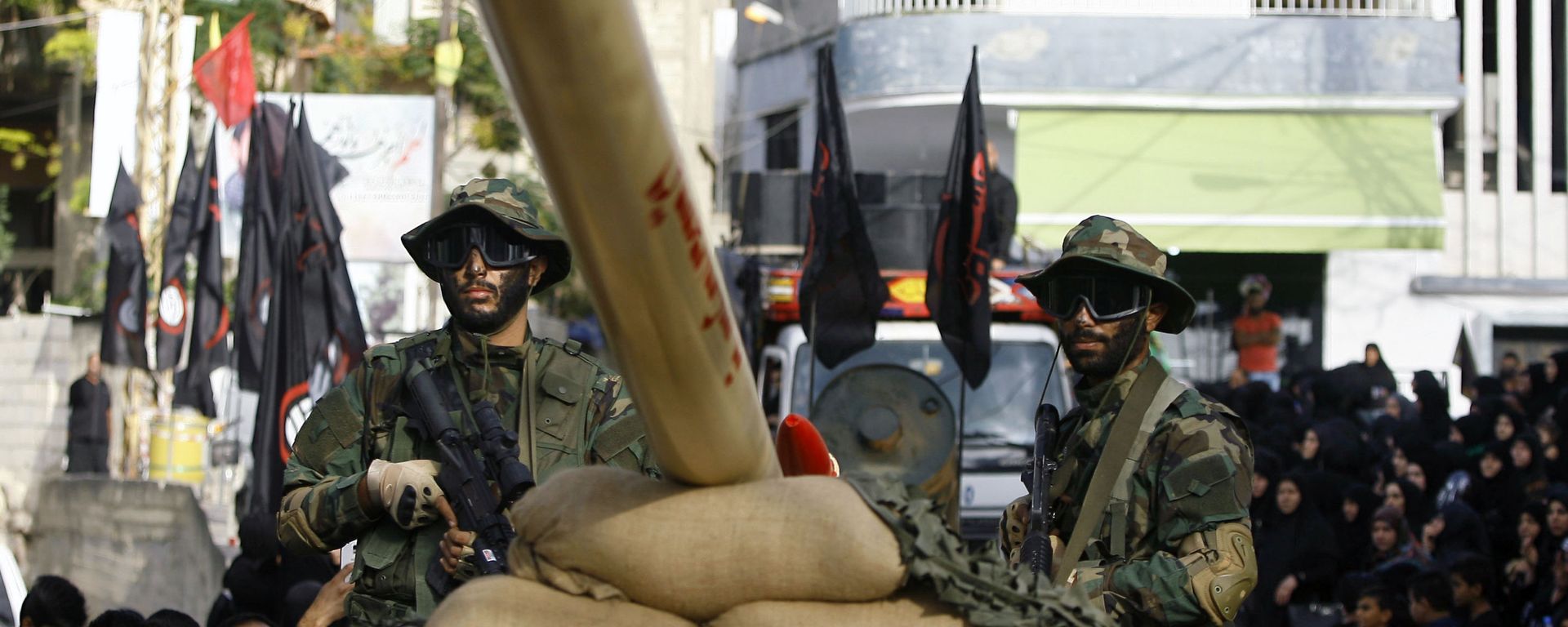 In this Sunday, Oct. 9, 2016 photo, Hezbollah fighters stand atop a car mounted with a mock rocket, as they parade during a rally to mark the seventh day of Ashoura, in the southern village of Seksakiyeh, Lebanon. In this Sunday, Oct. 9, 2016 photo, Hezbollah fighters stand atop a car mounted with a mock rocket, as they parade during a rally to mark the seventh day of Ashoura, in the southern village of Seksakiyeh, Lebanon. - Sputnik International, 1920, 20.10.2024