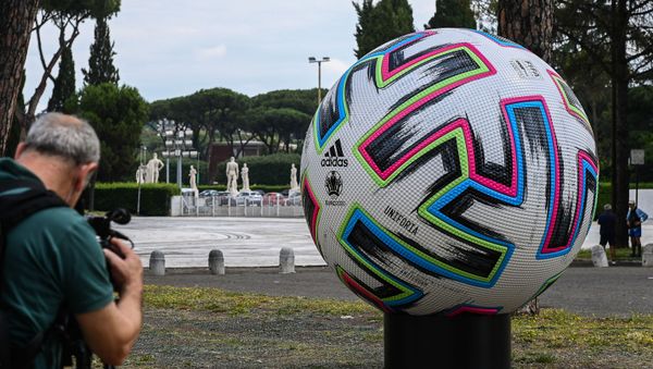 A video journalist films a giant football of the Euro 2020 European football tournament on 8 June 2021 by the Olympic stadium in Rome, three days before the delayed competition finally kicks off on June 11 in Rome when Italy hosts Turkey. A video journalist films a giant football of the Euro 2020 European football tournament on 8 June 2021 by the Olympic stadium in Rome, three days before the delayed competition finally kicks off on June 11 in Rome when Italy hosts Turkey. - Sputnik International