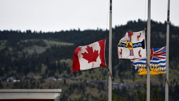 The Canadian flag flies at half-mast near the grounds of the former Kamloops Indian Residential School. - Sputnik International