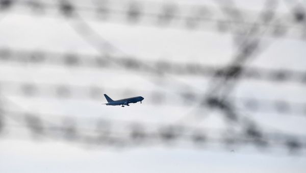 An Italian Boeing KC-767 military aerial refueling and strategic transport aircraft, transporting Italian citizens repatriated from the coronavirus hot-zone of Wuhan and to be placed in quarantine, prepares to land at the Mario De Bernardi military airport in Pratica di Mare, south of Rome, on February 3, 2020. - Sputnik International