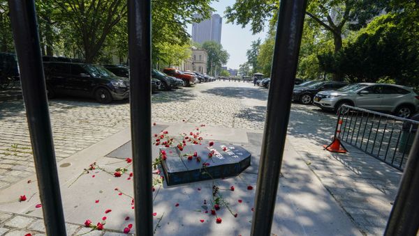 A cardboard coffin and red flowers are seen inside City Hall after activist threw them over the gate during a march and rally to demand the end of solitary confinement in New York, Monday, June 7, 2021. - Sputnik International
