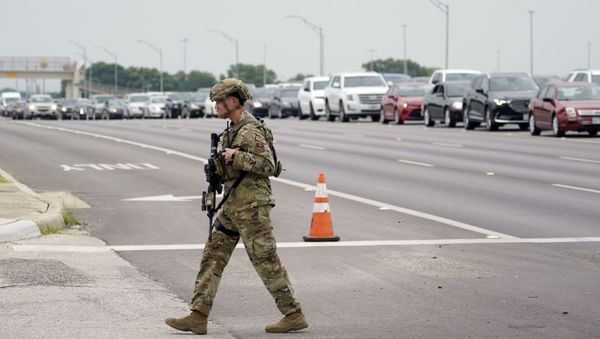 A military policeman walks past traffic outside of a JBSA-Lackland Air Force Base gate, Wednesday, June 9, 2021, in San Antonio. The Air Force was put on lockdown as police and military officials say they searched for two people suspected of shooting into the base from outside. - Sputnik International