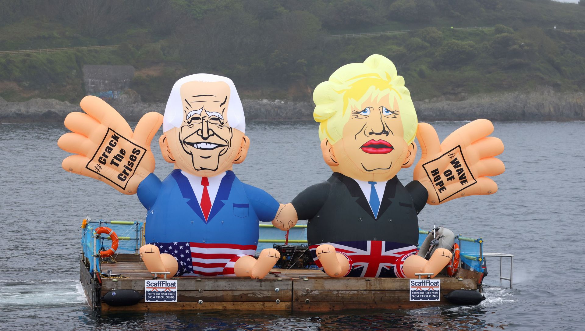 Inflatable dummies depicting U.S. President Joe Biden and Britain's Prime Minister Boris Johnson are displayed on a pontoon floating off Gyllyngvase Beach during an action organized by Crack the Crisis, in Falmouth, on the sidelines of G7 summit in Cornwall, Britain, June 11, 2021. Inflatable dummies depicting U.S. President Joe Biden and Britain's Prime Minister Boris Johnson are displayed on a pontoon floating off Gyllyngvase Beach during an action organized by Crack the Crisis, in Falmouth, on the sidelines of G7 summit in Cornwall, Britain, June 11, 2021. - Sputnik International, 1920, 11.06.2021