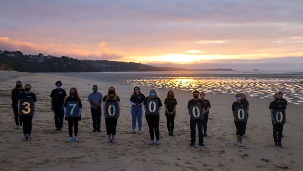 Activists from Crack the Crisis hold a vigil for the people around the world who have passed away due to the coronavirus disease (COVID-19) on the sidelines of G7 summit, at Porthkidney beach near Carbis Bay - Sputnik International