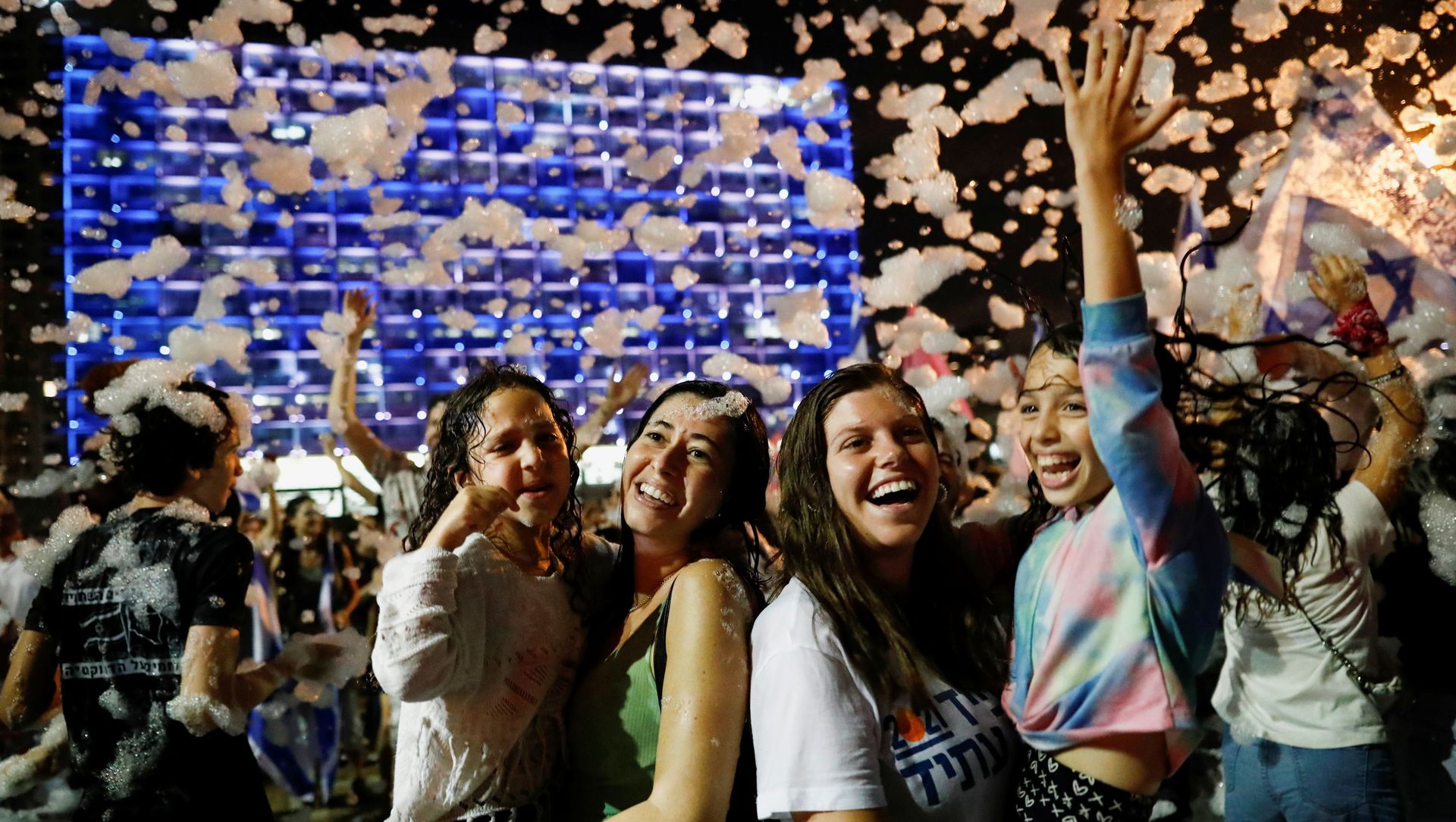 People celebrate after Israel's parliament voted in a new coalition government, ending Benjamin Netanyahu's 12-year hold on power, at Rabin Square in Tel Aviv, Israel June 13, 2021. People celebrate after Israel's parliament voted in a new coalition government, ending Benjamin Netanyahu's 12-year hold on power, at Rabin Square in Tel Aviv, Israel June 13, 2021. - Sputnik International, 1920, 13.06.2021