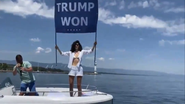 Screenshot from a video showing Osama bin Laden's niece, Noor bin Laden, protesting the Putin-Biden summit with a poster reading Trump won - Sputnik International