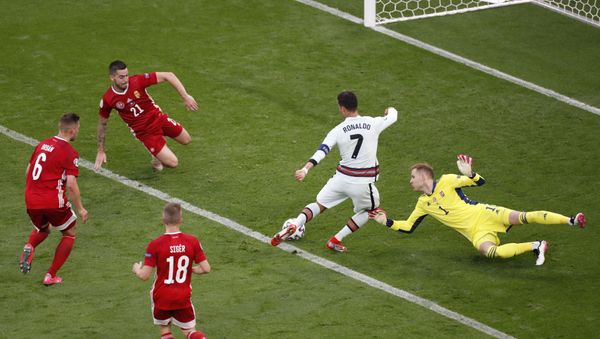 Soccer Football - Euro 2020 - Group F - Hungary v Portugal - Puskas Arena, Budapest, Hungary - 15 June 2021 Portugal's Cristiano Ronaldo rounds Hungary's Peter Gulacsi as he scores their third goal Soccer Football - Euro 2020 - Group F - Hungary v Portugal - Puskas Arena, Budapest, Hungary - 15 June 2021 Portugal's Cristiano Ronaldo rounds Hungary's Peter Gulacsi as he scores their third goal - Sputnik International