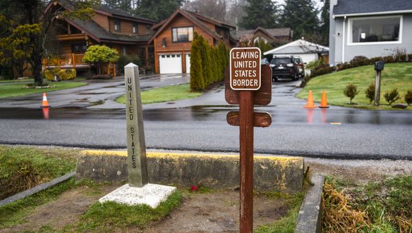 A walkway between the U.S. and Canada is seen as Canadians and Americans visit at Peace Arch Historical State Park on January 1, 2021 in Blaine, Washington. Canadians and Americans have been using the scenic park, situated on the U.S.-Canada border, as a place to reunite during ongoing border closures.   - Sputnik International