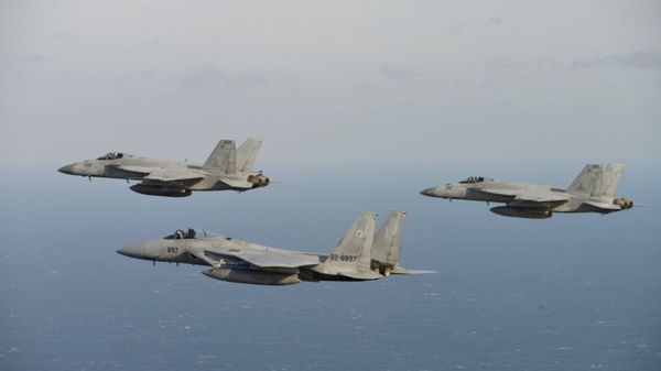 In this Nov. 10, 2017 photo provided by Japan Air Self-Defense Force, two of U.S. F/A-18, left, and right, and Japan Air Self-Defense Force's F-15 fly during a joint military exercise at an undisclosed location.  (Japan Air Self-Defense Force via AP) - Sputnik International