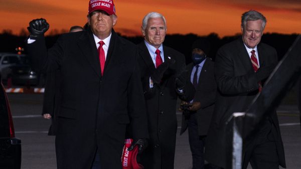 President Donald Trump and Vice President Mike Pence arrive for a campaign rally at Cherry Capital Airport, Monday, Nov. 2, 2020, in Traverse City, Mich., with White House chief of staff Mark Meadows, right. Meadows has been diagnosed with the coronavirus as the nation sets daily records for confirmed cases for the pandemic - Sputnik International