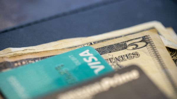 In this Aug. 11, 2019 file photo, U.S. currency and credit cards sit on a table at a restaurant in New Orleans. - Sputnik International