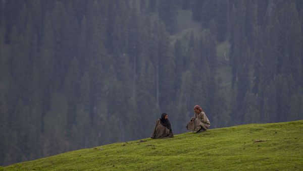 Kashmiri village women talk as they sit on a hillock in Tosamaidan, southwest of Srinagar, Indian controlled Kashmir, Monday, June 21, 2021. - Sputnik International