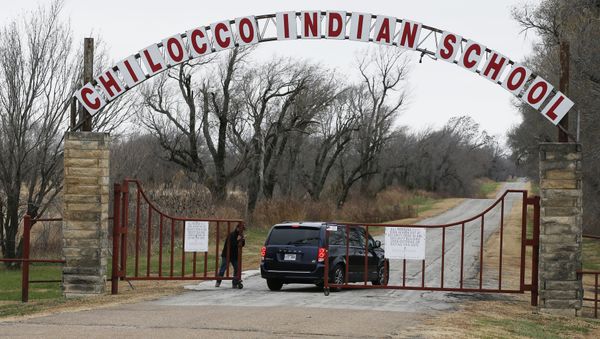 In this Wednesday, Nov. 29, 2017 file photo, a vehicle arrives at the abandoned Chilocco Indian School campus in Newkirk, Okla, Five American Indian tribes are opposing plans by the U.S. Department of Homeland Security to conduct bioterrorism drills at a tribal burial ground and abandoned boarding school, saying the agency didn't tell them that potentially dangerous substances could be used there. - Sputnik International