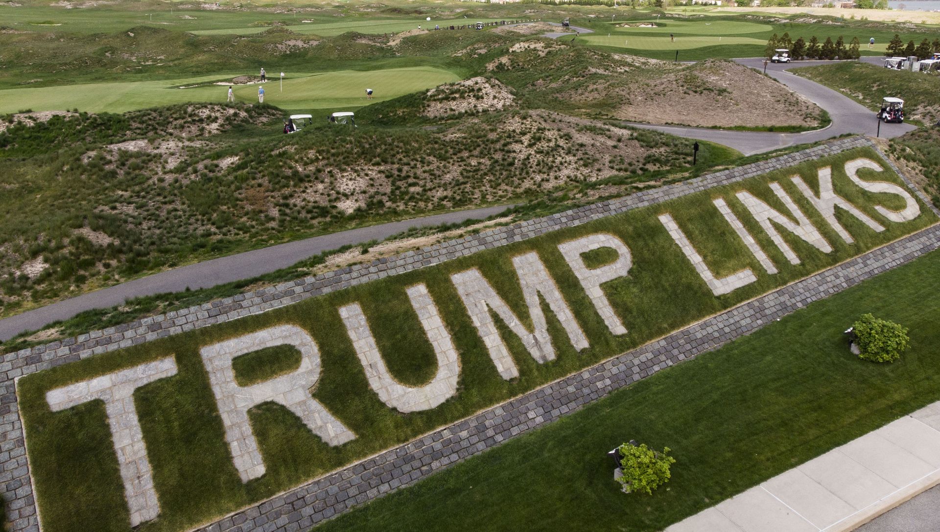 FILE - Patrons play the links as a giant branding sign is displayed with flagstones at Trump Golf Links at Ferry Point in the Bronx borough of New York on Tuesday, May 4, 2021. The Trump Organization sued New York City on Monday, June 21, 2021 for cancelling its contract to run a golf course in the Bronx earlier this year, a move it called ''politically motivated with no basis in the law that should be reversed. FILE - Patrons play the links as a giant branding sign is displayed with flagstones at Trump Golf Links at Ferry Point in the Bronx borough of New York on Tuesday, May 4, 2021. The Trump Organization sued New York City on Monday, June 21, 2021 for cancelling its contract to run a golf course in the Bronx earlier this year, a move it called ''politically motivated with no basis in the law that should be reversed. - Sputnik International, 1920, 22.06.2021