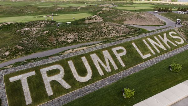 FILE - Patrons play the links as a giant branding sign is displayed with flagstones at Trump Golf Links at Ferry Point in the Bronx borough of New York on Tuesday, May 4, 2021. The Trump Organization sued New York City on Monday, June 21, 2021 for cancelling its contract to run a golf course in the Bronx earlier this year, a move it called ''politically motivated with no basis in the law that should be reversed. - Sputnik International