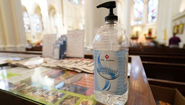 A bottle of hand sanitizer stands near an entrance to Cathedral Basilica of the Immaculate Conception, where Christmas services were being held Thursday, Dec. 24, 2020, in Denver. - Sputnik International