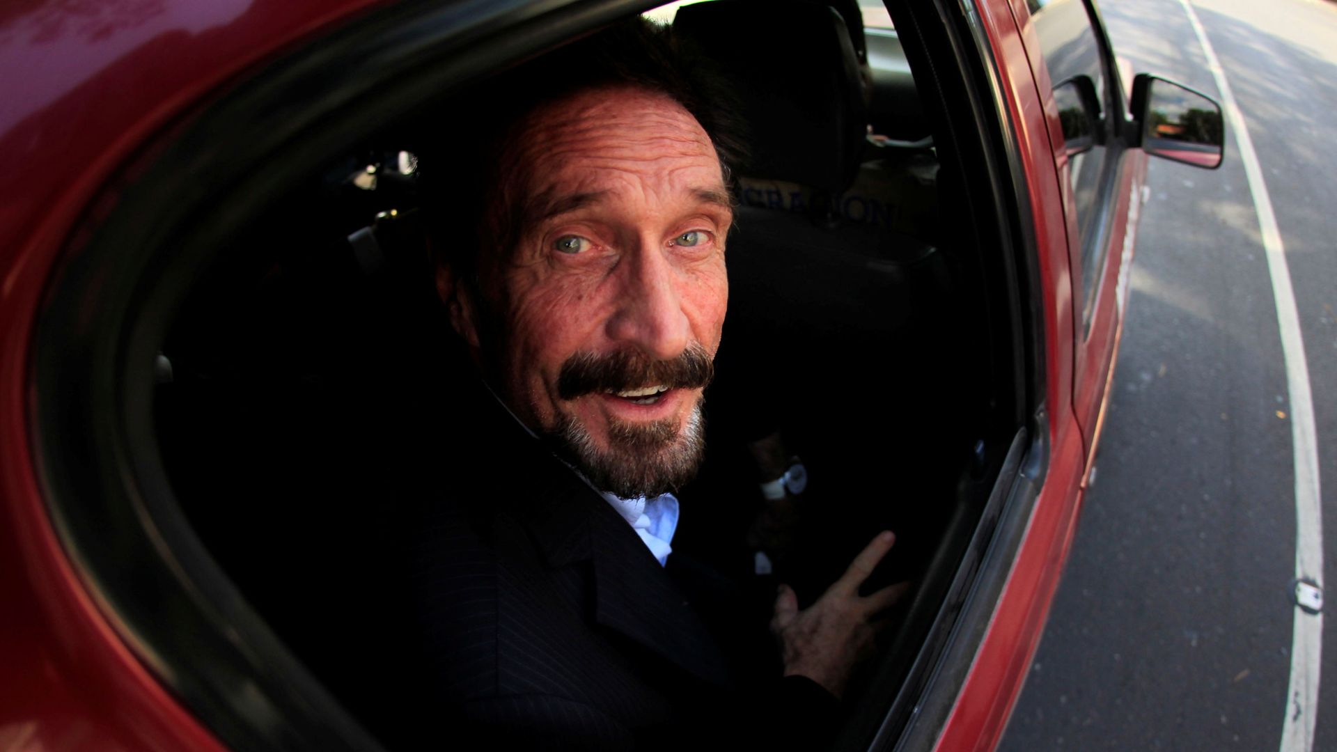 Software pioneer John McAfee is escorted by immigration officers to the Guatemalan Airport in Guatemala City December 12, 2012. Software pioneer John McAfee is escorted by immigration officers to the Guatemalan Airport in Guatemala City December 12, 2012. - Sputnik International, 1920, 15.07.2021