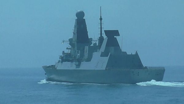 British Navy's Defender destroyer sails in the Black Sea near the Cape Fiolent after entering Russia's territorial waters, in Crimea, Russia - Sputnik International