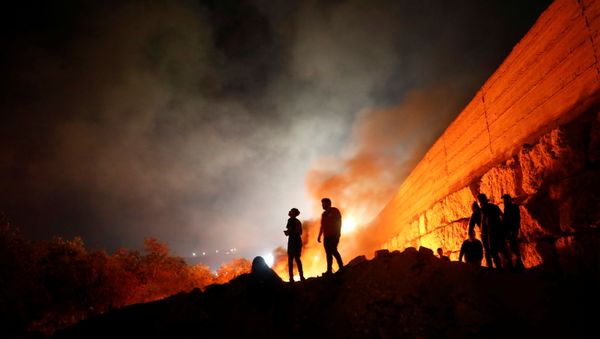 Palestinian demonstrators take part in a night protest against Israeli settlements in Beita in the Israeli-occupied West Bank, June 22, 2021. Picture taken June 22, 2021. - Sputnik International