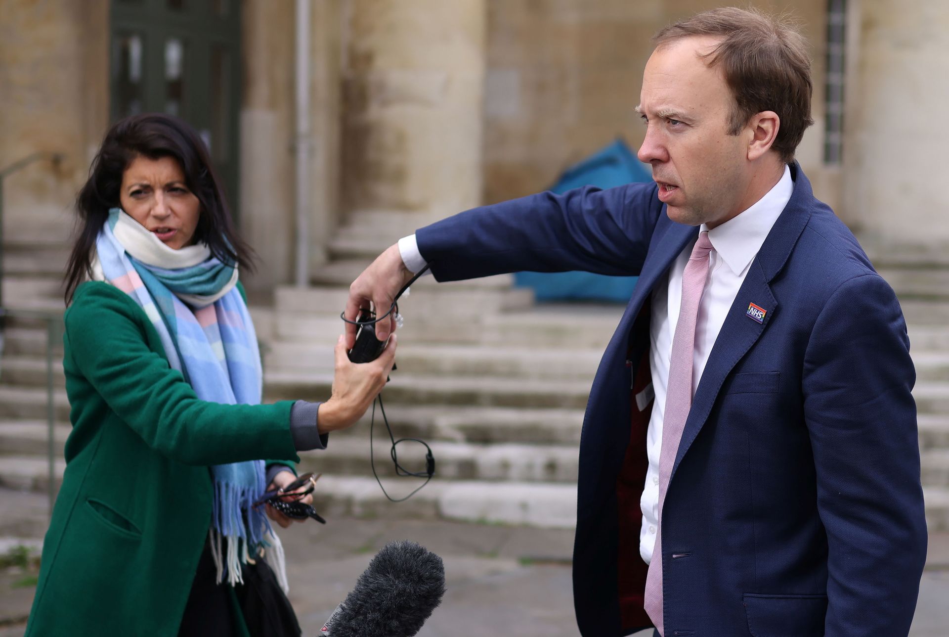 Britain's Health Secretary Hancock hands a microphone to his aide Coladangelo following a television interview outside BBC in London - Sputnik International, 1920, 06.12.2021