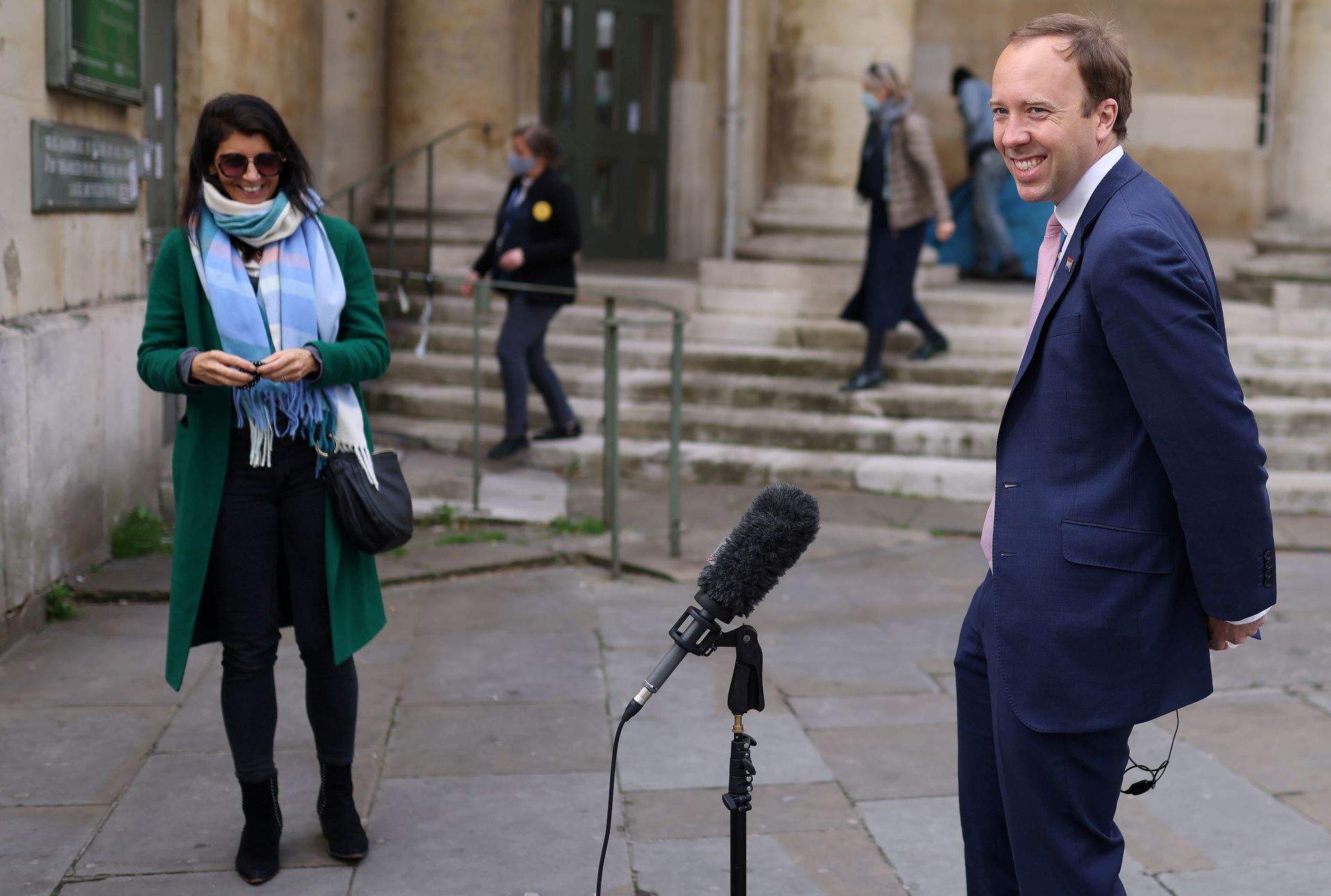 Britain's Health Secretary Matt Hancock smiles during a television interview as his aide Gina Coladangelo looks on, outside BBC's Broadcasting House in London Britain's Health Secretary Matt Hancock smiles during a television interview as his aide Gina Coladangelo looks on, outside BBC's Broadcasting House in London - Sputnik International, 1920, 07.09.2021