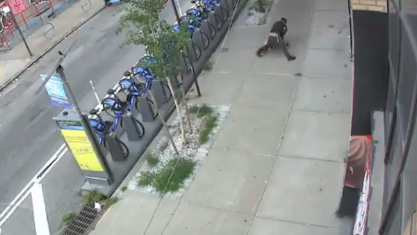 Screenshot from a NYPD video showing a man tackling a woman and groping her in Brooklyn, New York City - Sputnik International