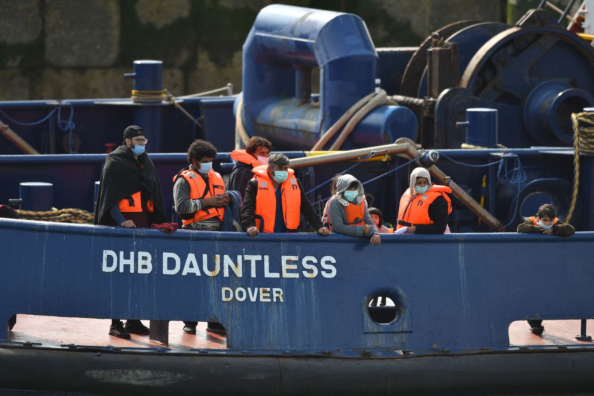 Waleed (3L), 29, a Kuwaiti migrant, stands with other migrants onboard the DHB Dauntless tug boat as they are brought to shore by the UK Border Force after illegally crossing the English Channel from France on a dinghy on September 11, 2020, in the marina at Dover, on the south coast of England Waleed (3L), 29, a Kuwaiti migrant, stands with other migrants onboard the DHB Dauntless tug boat as they are brought to shore by the UK Border Force after illegally crossing the English Channel from France on a dinghy on September 11, 2020, in the marina at Dover, on the south coast of England - Sputnik International, 1920, 07.09.2021