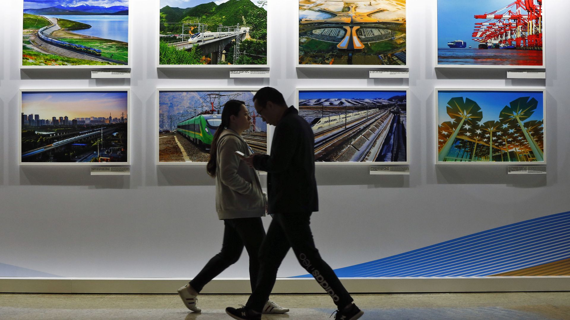 In this Saturday, April 27, 2019 file photo, people walk by a display board showcasing China's sweeping infrastructure-building projects at the media center of the Belt and Road Forum in Beijing - Sputnik International, 1920, 07.07.2021