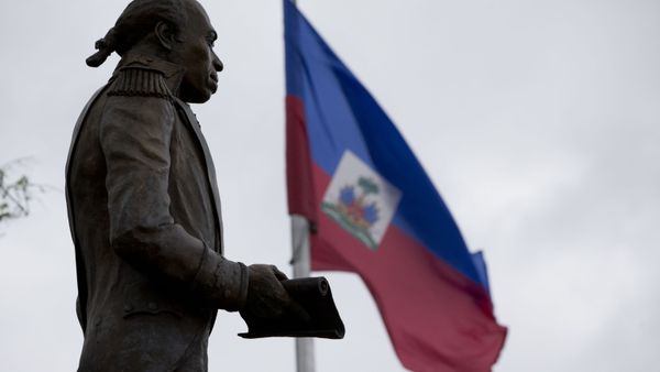 A Haitian flag flies next to a statue of Toussaint Louverture in the Little Haiti neighborhood, Friday, Jan. 12, 2018, in Miami.  - Sputnik International