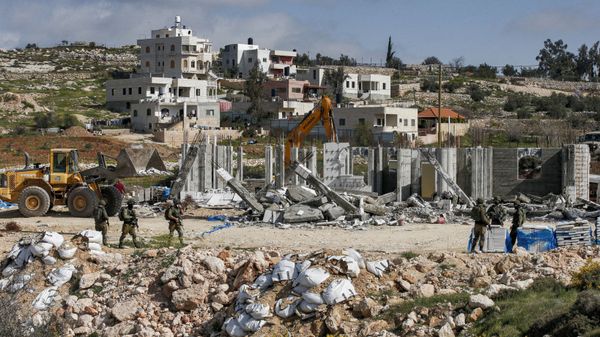Israeli soldiers stand by as excavators demolish a Palestinian house (still under construction) located within the area C (where Israel retains full control over planning and construction) southeast of Hebron in the occupied West Bank on March 8, 2021. - Sputnik International