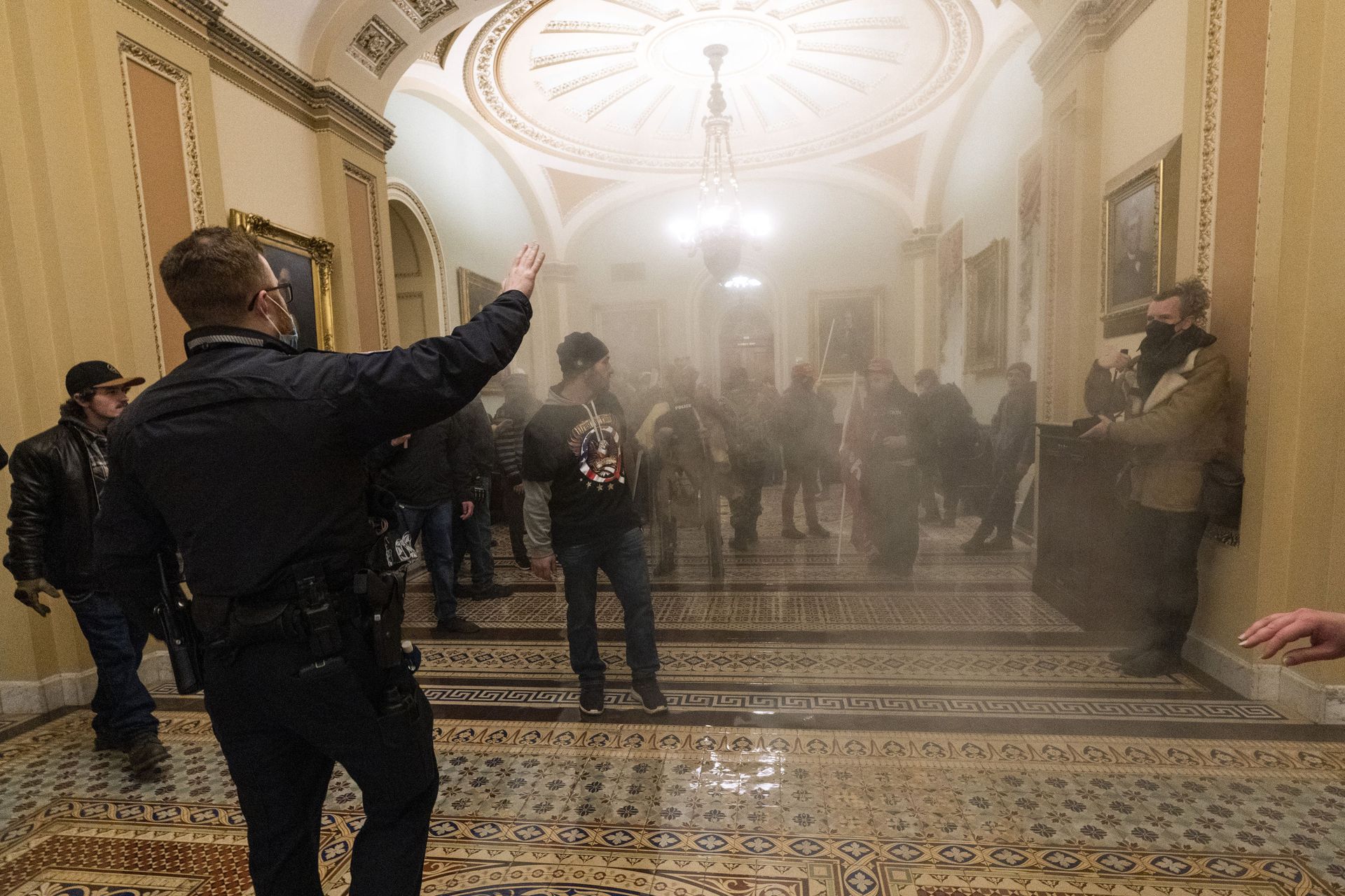 FILE - In this Jan. 6, 2021, file photo, smoke fills the walkway outside the Senate Chamber as rioters are confronted by U.S. Capitol Police officers inside the Capitol in Washington - Sputnik International, 1920, 07.09.2021