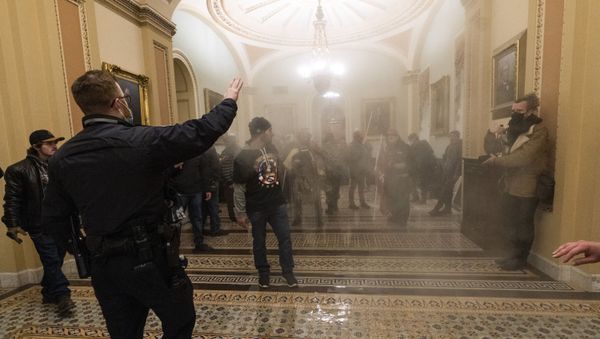 FILE - In this Jan. 6, 2021, file photo, smoke fills the walkway outside the Senate Chamber as rioters are confronted by U.S. Capitol Police officers inside the Capitol in Washington - Sputnik International