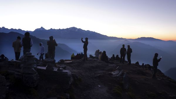 Indian tourists take selfies as other wait to view sun rise at the Chandrashilla Peak in Himalaya at Tungnath in the Indian state of Uttarakhand, Monday, Oct.19, 2020 - Sputnik International