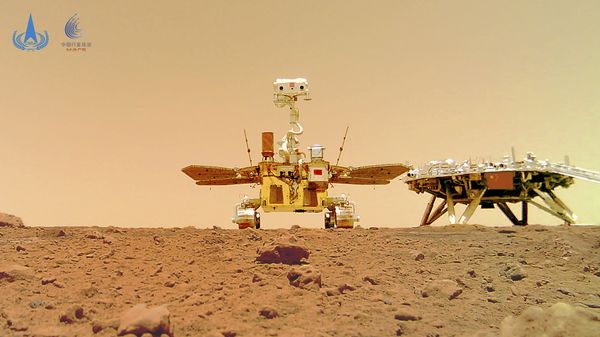 In this image released by the China National Space Administration (CNSA) on Friday, June 11, 2021, the Chinese Mars rover Zhurong is seen near its landing platform taken by a remote camera that was dropped into position by the rover. - Sputnik International