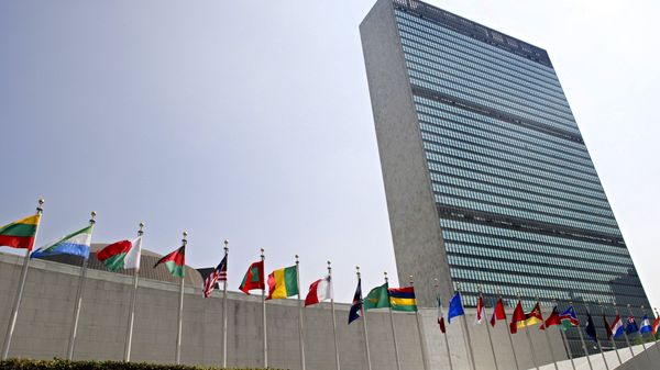 In this Sept. 13, 2005, file photo, the flags of member nations fly outside the General Assembly building at the United Nations headquarters in New York. - Sputnik International