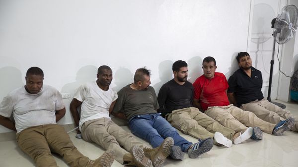 Suspects in the assassination of Haiti's President Jovenel Moise, among them Haitian-American citizens James Solages, left, and Joseph Vincent, second left, are shown to the media at the General Direction of the police in Port-au-Prince, Haiti, Thursday, July 8, 2021 - Sputnik International